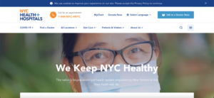 NYC Health + Hospitals website homepage features a close-up of a smiling person wearing glasses and a face mask 
